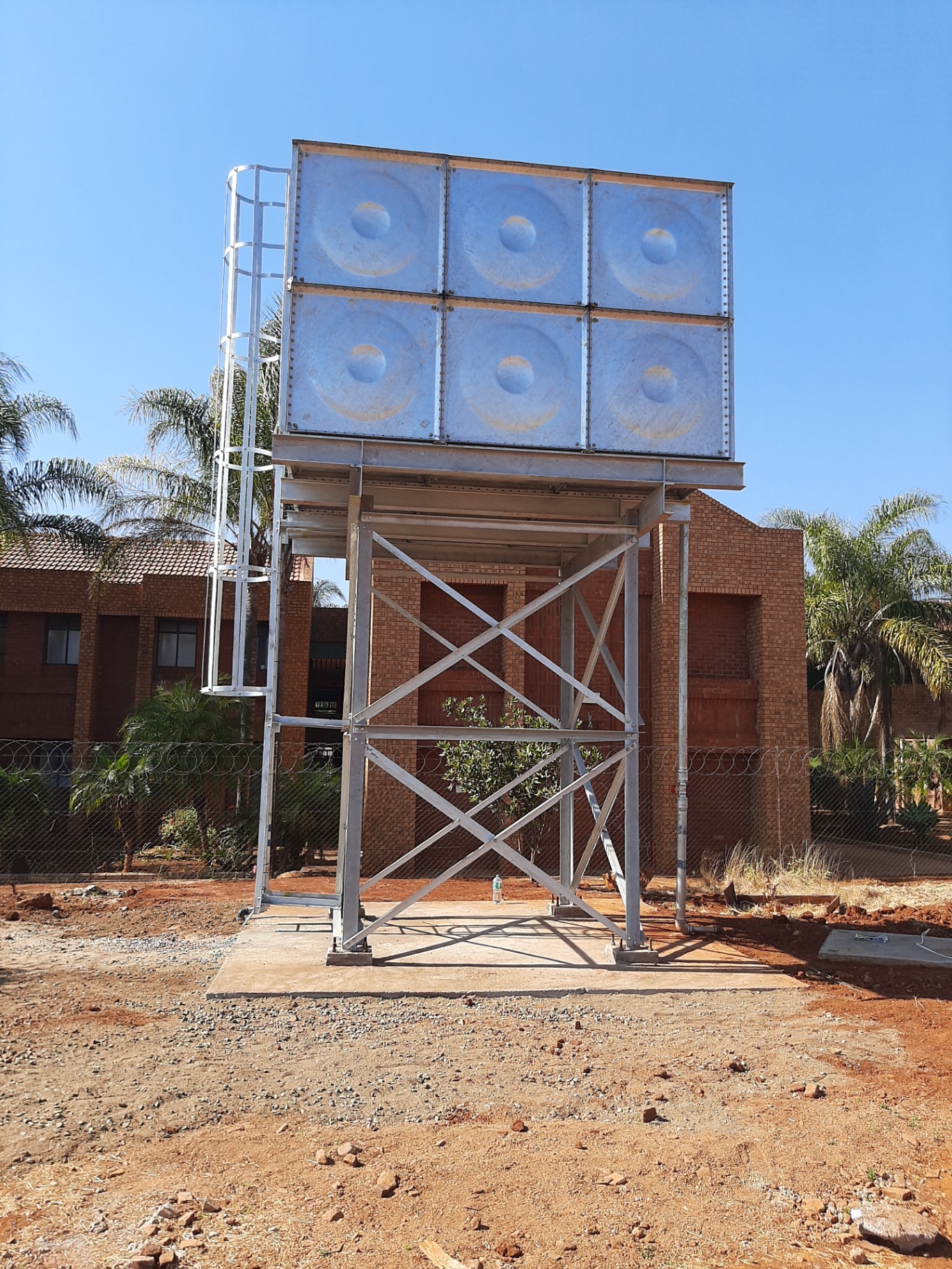 Elevated galvanized steel water tank front view at Waterberg College